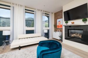 a living room with a couch and a fireplace at Leadville Penthouse #8 in Ketchum