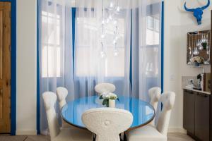a dining room with a blue table and chairs at Leadville Penthouse #8 in Ketchum