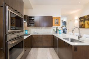 a large kitchen with a sink and a refrigerator at Leadville Penthouse #8 in Ketchum