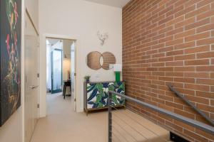 a hallway with a brick wall and a staircase at Leadville Penthouse #8 in Ketchum