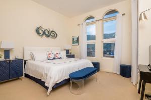 a bedroom with a large bed and two windows at Leadville Penthouse #8 in Ketchum +3 photos