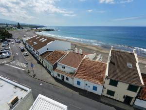 a view of a beach with buildings and the ocean at Casa do Mar South in Ponta Delgada