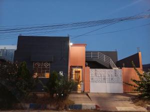 a black and orange building with a door at house dream in Berkane
