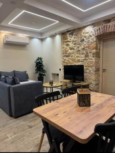 a living room with a couch and a table at Downtown ViAlla Studio in Chios
