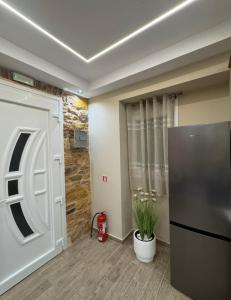 a room with a door and a plant in it at Downtown ViAlla Studio in Chios +4 photos