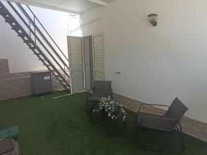 an empty room with two chairs and a staircase at Costa Marina in Marsala