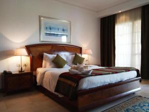 a bedroom with a bed with a teddy bear on it at فندق دلتا شرم in Sharm El Sheikh