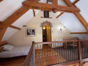 an attic room with a wooden staircase and a stair case at Ticoulat in Monein
