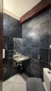 a bathroom with a sink and a toilet at Beleleus Jeri in Jericoacoara