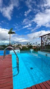 a large blue swimming pool with a water slide at Beleleus Jeri in Jericoacoara +22 photos