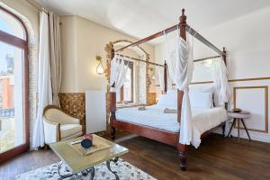 a bedroom with a canopy bed and a table at L'étoile d'Arras in Arras +180 photos