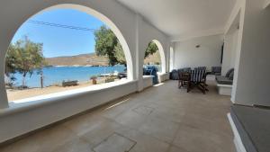 a living room with a view of the water at Ankon Beach House Kythnos in Kithnos