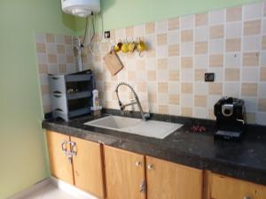 a kitchen counter with a sink and a microwave at house dream in Berkane