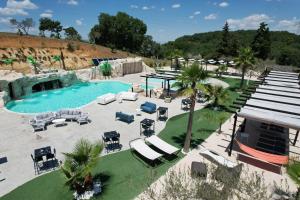 an overhead view of a pool with chaise lounge chairs and a resort at Tenuta Lunoa in Salandra