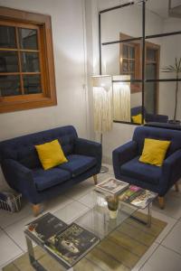 a living room with two blue couches and a table at Maison verte - Guest House in Arequipa