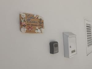 a christmas sign on a wall next to a safe at Costa Marina in Marsala +2 photos