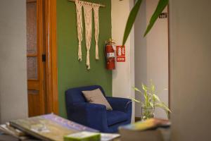 a living room with a blue chair and a fire hydrant at Maison verte - Guest House in Arequipa