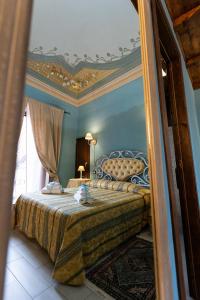 a bedroom with a large bed with a mirror at Palazzo Diamante in Calascio +30 photos