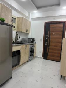a kitchen with a refrigerator and a stove top oven at Résidence privée à hurgada avec piscine in Hurghada