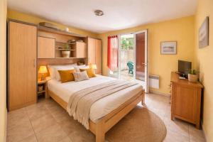 a bedroom with a large bed and a window at 45 Méditerranée in Ortaffa
