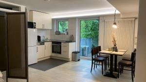 a kitchen and dining room with a table and chairs at Wohnatelier Calw in Calw