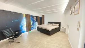 a bedroom with a bed and a chair in it at Wohnatelier Calw in Calw