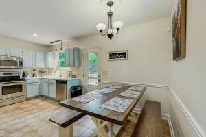 a large kitchen with a wooden table in it at Rustic Retreat in Franklin
