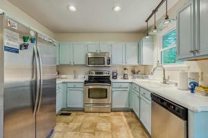 a kitchen with blue cabinets and a stainless steel refrigerator at Rustic Retreat in Franklin