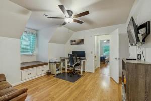 a living room with a ceiling fan and a desk at Rustic Retreat in Franklin +12 photos