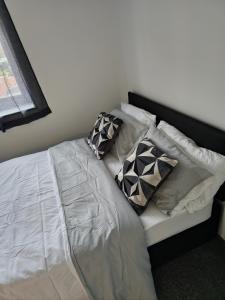 a bed with pillows on it in a bedroom at Chilux in Rainham