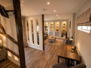 a large living room with a couch and a table at The Stalls Suite at Strattons in Swaffham