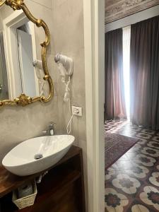 a bathroom with a white sink and a mirror at DS Apartment in Catania +119 photos