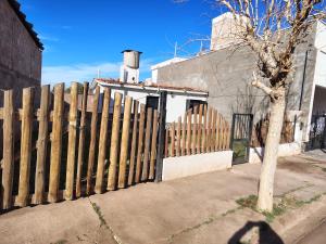 a wooden fence in front of a house at La casita de José in Villa Unión