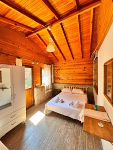 a bedroom with a bed and a wooden ceiling at Petrinos Butik Otel in Datca