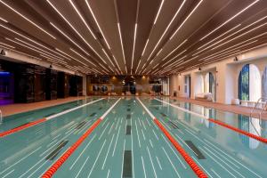 a large swimming pool with lanes in the middle at Cortina North Luxury Studio in Voluntari
