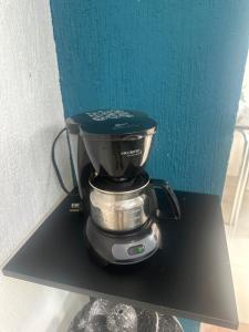 a coffee maker sitting on top of a black shelf at Adarax Playa Hermosa in Cancún