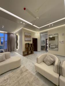 a large living room with two couches and a couch at بنايه بيت الشب in Ţāqah