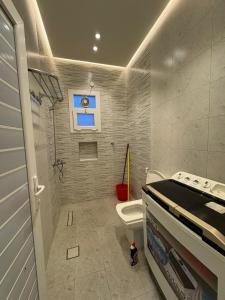 a bathroom with a toilet and a sink at بنايه بيت الشب in Ţāqah +39 photos