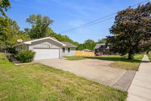 a house with a white garage and a driveway at Private Heated Pool House with Sauna CL in Crystal Lake