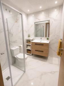 a bathroom with a toilet and a sink and a shower at Benidorm Center Playa Poniente in Benidorm +57 photos