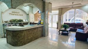 a lobby with a hotel terrazas sign on the wall at Hotel Terraza in San Pedro Sula