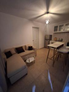 a living room with a couch and a table at Acogedor Departamento Entero in Hornillo +3 photos