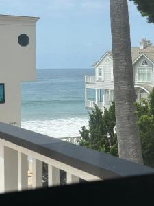 a view of the ocean from the balcony of a house at Malibu Surf Cottage on Lechuza Beach in Malibu