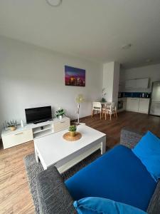 a living room with a couch and a table at Cube Apartamenty in Lublin