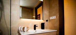 a bathroom with a sink and a mirror at Forrent malaga in Málaga