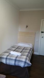 a bedroom with a bed and a desk at Lynden Court Hotel in Bournemouth