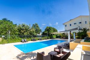 a swimming pool with chairs and a building at Hispaniola Residential - Villas & Apartments! in Sosúa +20 photos