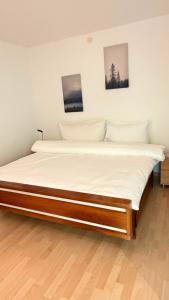 a large bed in a room with two pictures on the wall at Apollo in Saas-Fee