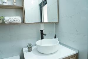 a bathroom with a white sink and a mirror at Kostadinov Residence in Demir Kapija +32 photos