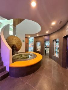 a lobby with a fountain in the middle of a building at Rental Higueron Boutique Resort in Fuengirola +24 photos